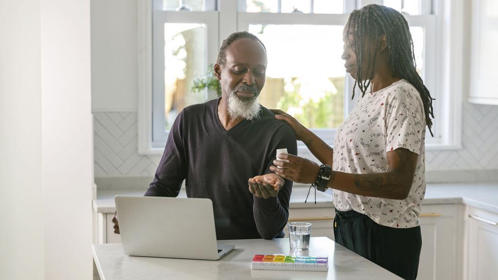 Woman giving man pill