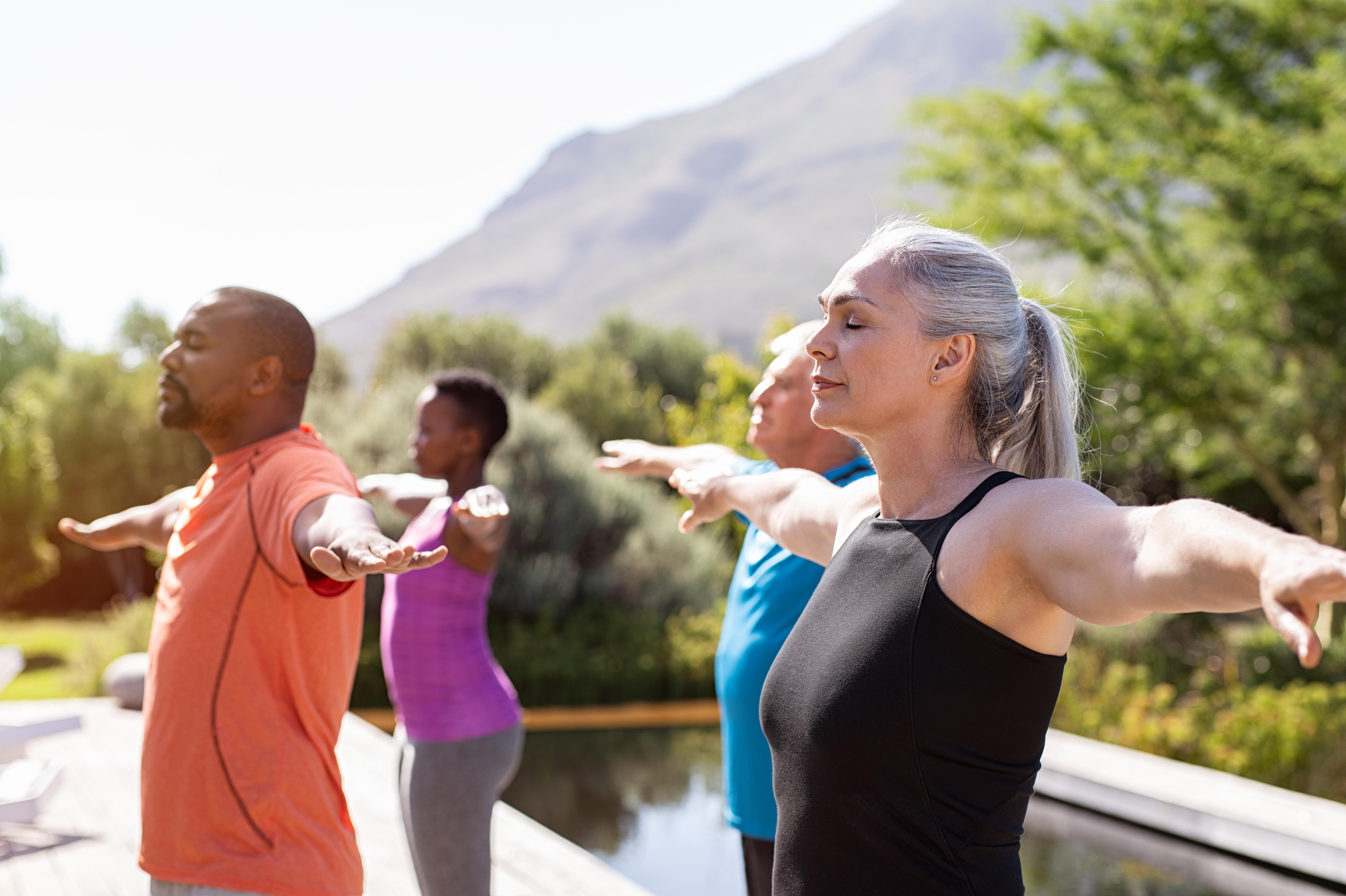 People doing yoga outside