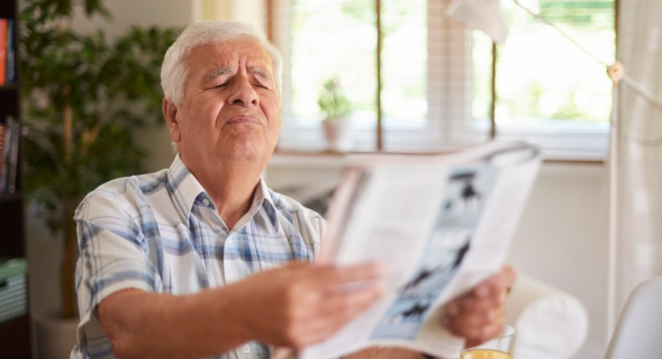 Man struggling to read