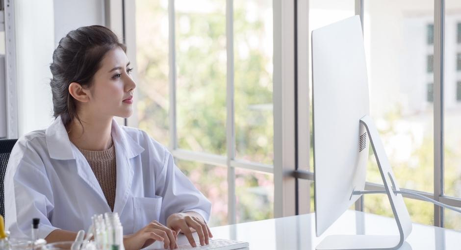 Medical professional looking at computer