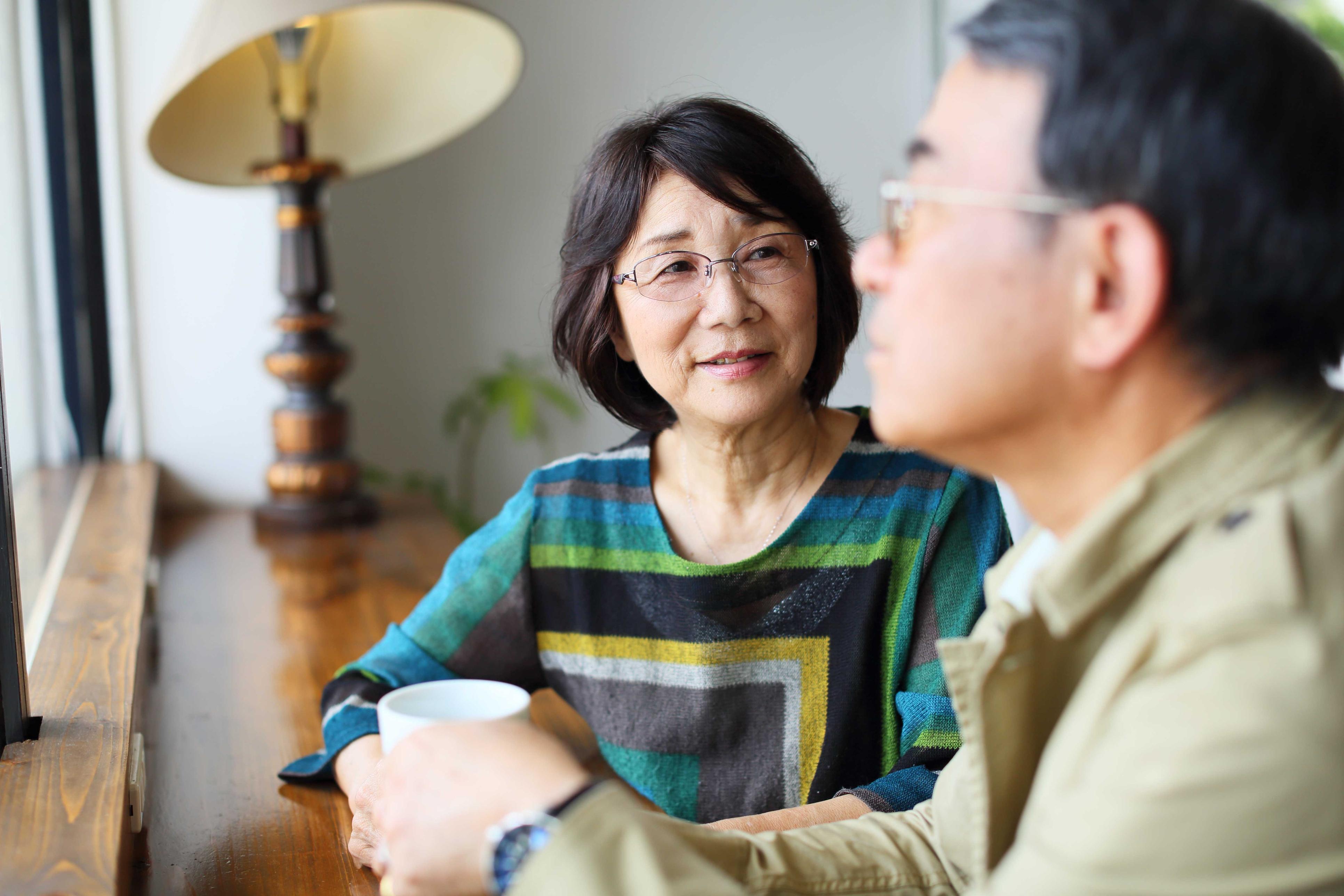 Couple talking to each other over coffee