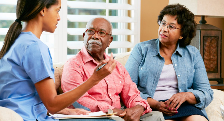 Man and woman speaking with health professional